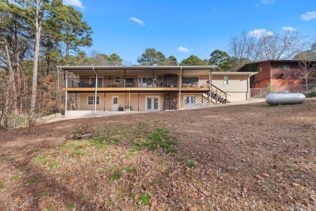 back of house featuring french doors, fence, and a patio