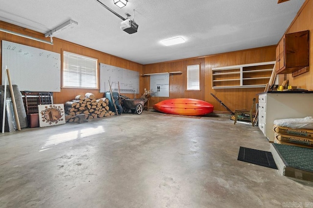 garage featuring wood walls and a garage door opener