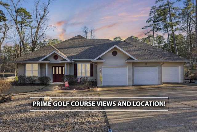 view of front of house with a garage, driveway, and roof with shingles