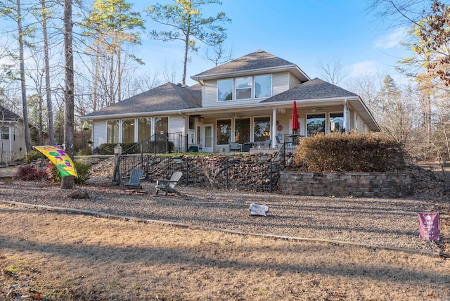 view of front of home featuring a fenced front yard, a porch, and a shingled roof