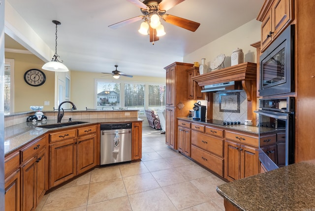 kitchen with black appliances, a sink, and brown cabinets