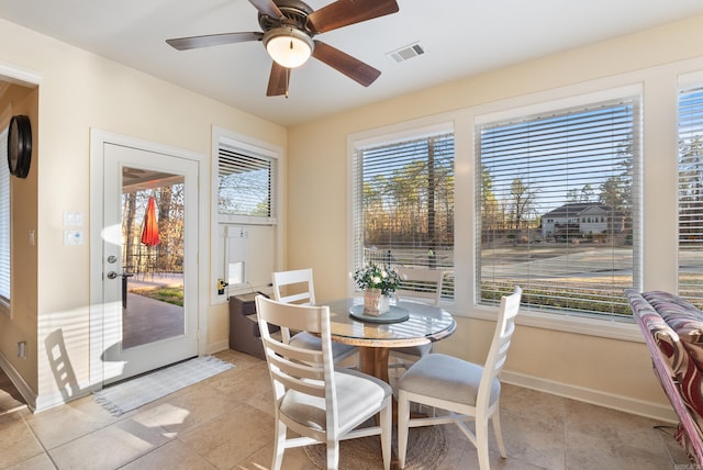 dining space featuring a ceiling fan, visible vents, and baseboards