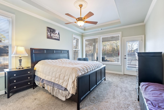 bedroom featuring visible vents, light colored carpet, ornamental molding, access to outside, and a tray ceiling