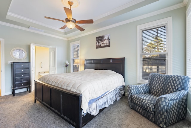 carpeted bedroom with a raised ceiling, crown molding, and baseboards