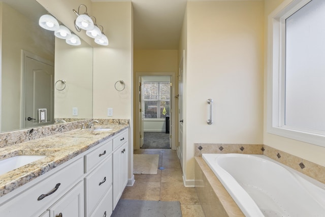 bathroom featuring double vanity, tiled bath, a sink, and tile patterned floors