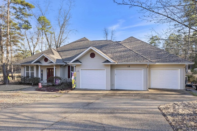 view of front of home featuring an attached garage and roof with shingles