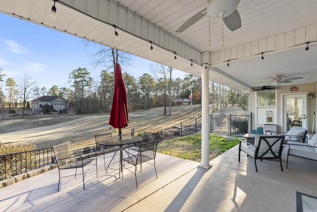 view of patio featuring a ceiling fan, outdoor dining area, and fence