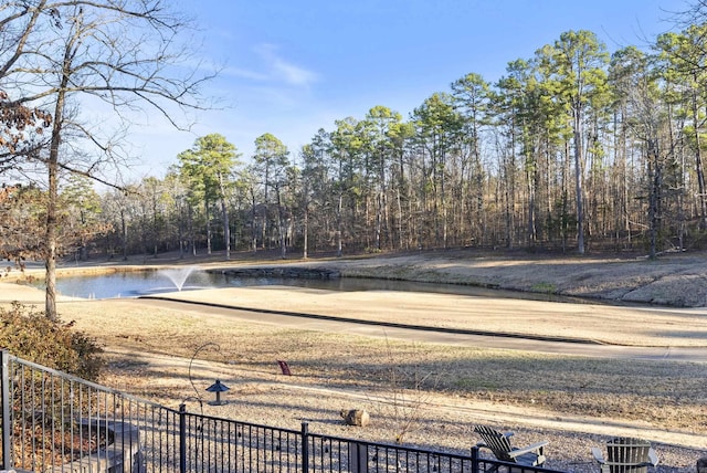 view of yard featuring a water view and fence