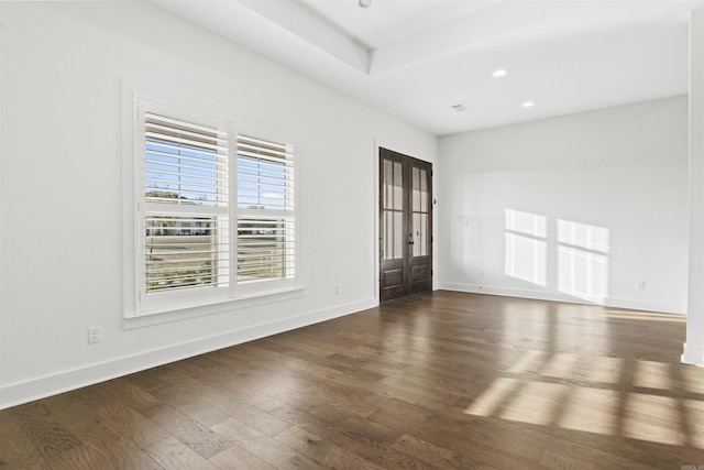 unfurnished room with a tray ceiling, french doors, recessed lighting, wood finished floors, and baseboards