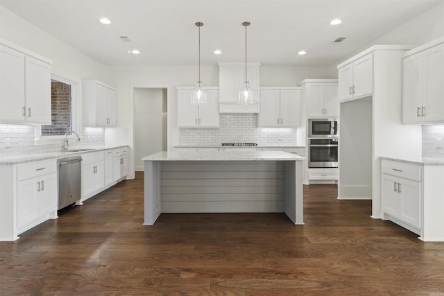 kitchen featuring dark wood-style floors, stainless steel appliances, a sink, and white cabinets