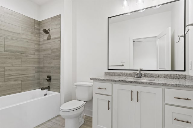 bathroom featuring shower / tub combination, vanity, and toilet