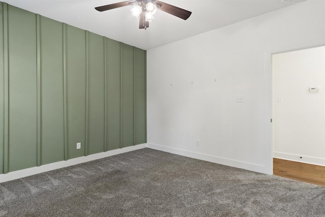 unfurnished room featuring ceiling fan, baseboards, and dark colored carpet