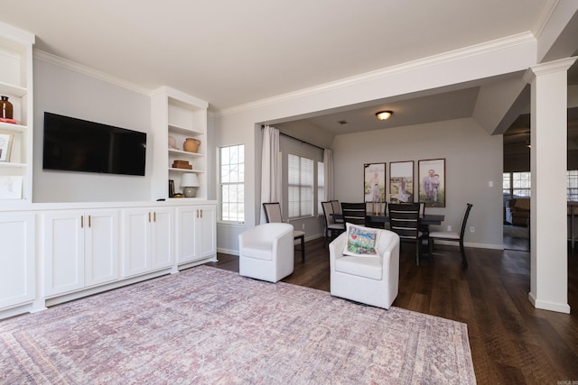 living area with ornamental molding, dark wood-type flooring, decorative columns, and baseboards