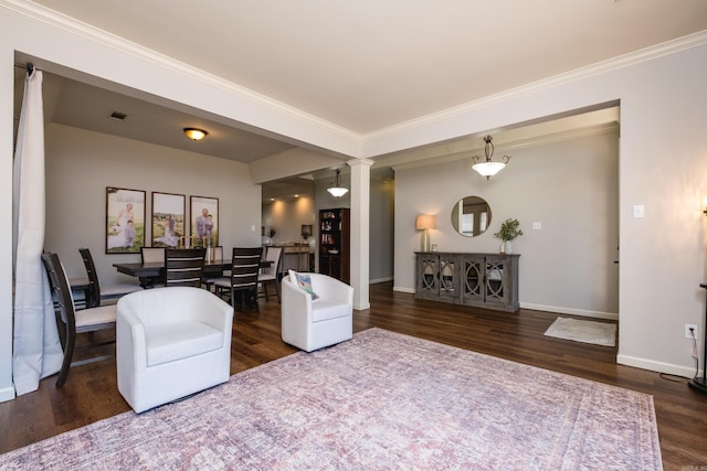 interior space featuring ornate columns, visible vents, ornamental molding, wood finished floors, and baseboards