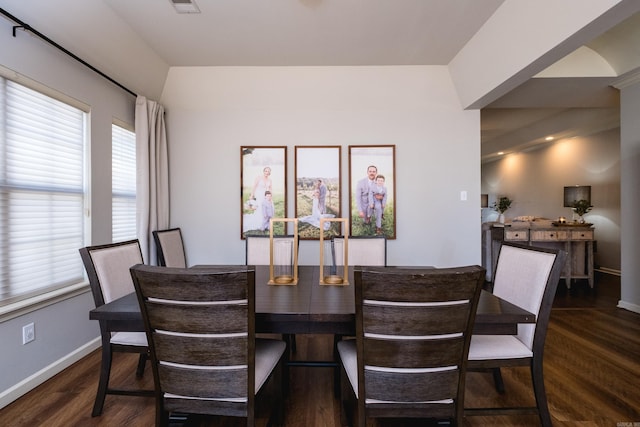 dining space with wood finished floors, visible vents, and baseboards