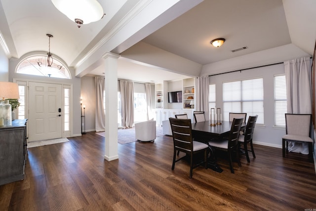 dining area featuring built in shelves, visible vents, dark wood finished floors, and ornate columns