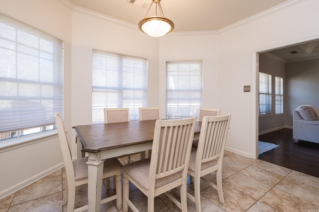 dining area with light tile patterned floors, baseboards, visible vents, and ornamental molding