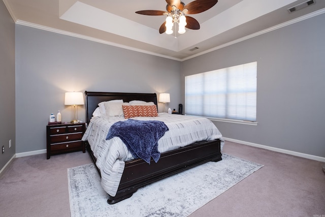 bedroom featuring a tray ceiling, carpet, visible vents, and baseboards