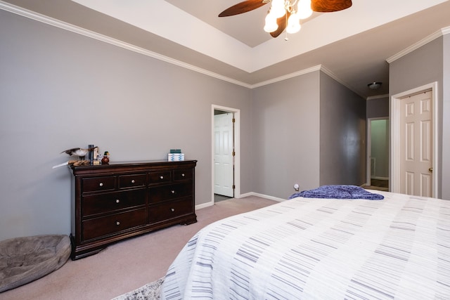 bedroom featuring baseboards, a raised ceiling, ceiling fan, ornamental molding, and carpet