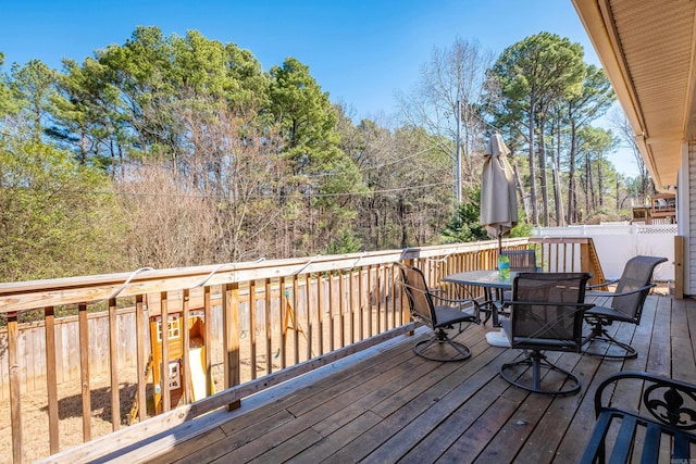 wooden deck featuring outdoor dining area and fence