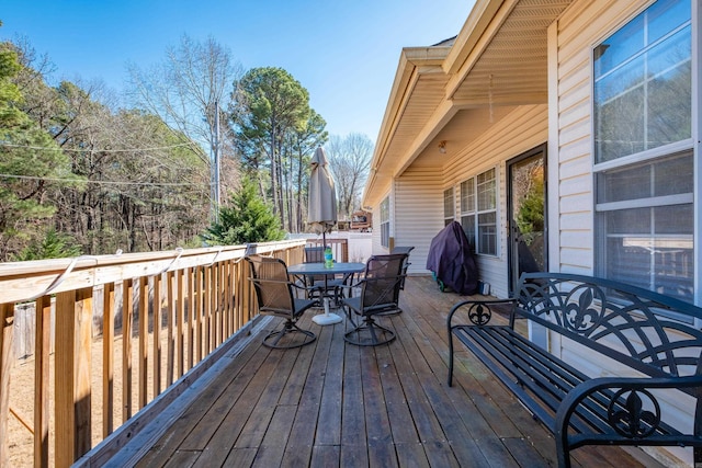 wooden terrace with outdoor dining area