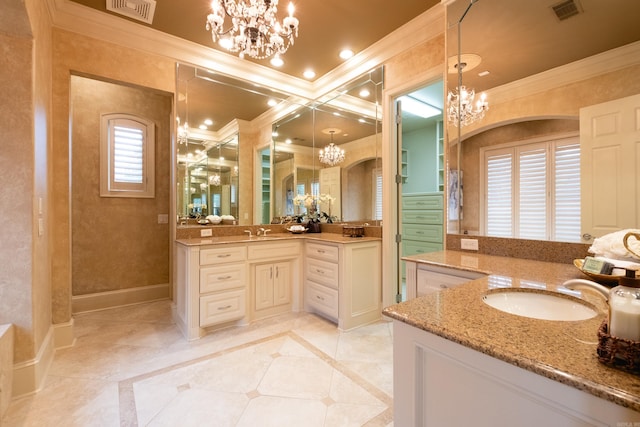 bathroom featuring a chandelier, a sink, and visible vents