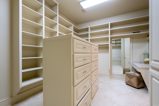 spacious closet with light tile patterned floors