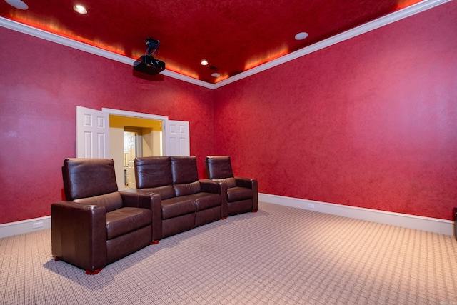 cinema room with carpet floors, crown molding, and baseboards