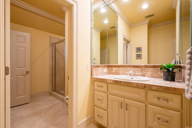 bathroom with vanity, ornamental molding, a shower stall, and visible vents