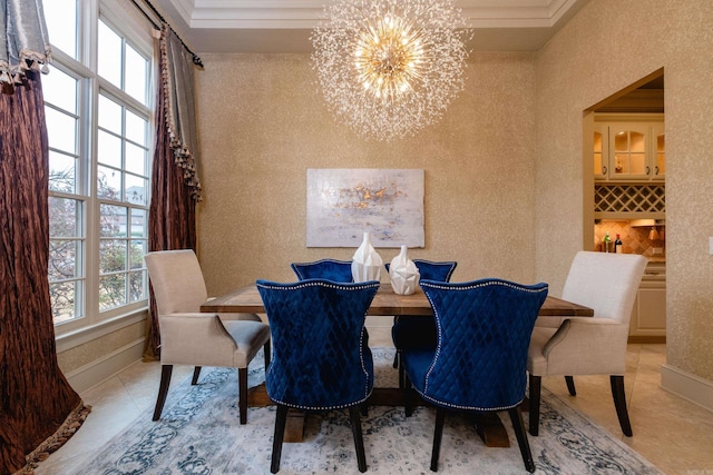 dining area with plenty of natural light, a notable chandelier, and baseboards