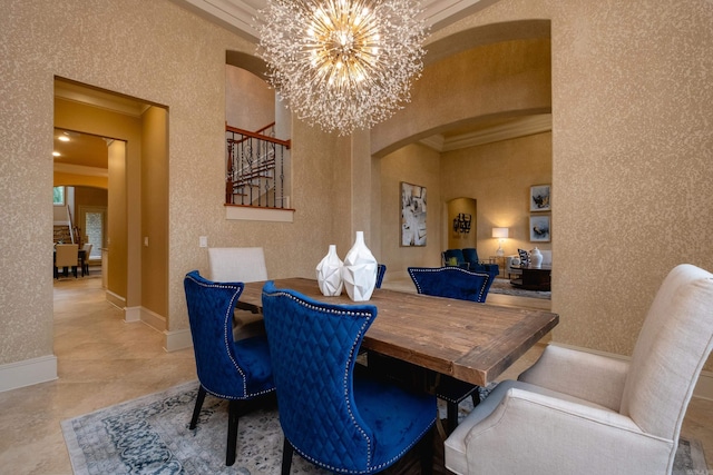 dining space with crown molding, arched walkways, a notable chandelier, and wallpapered walls