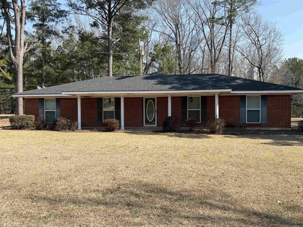 ranch-style house with a front yard and brick siding