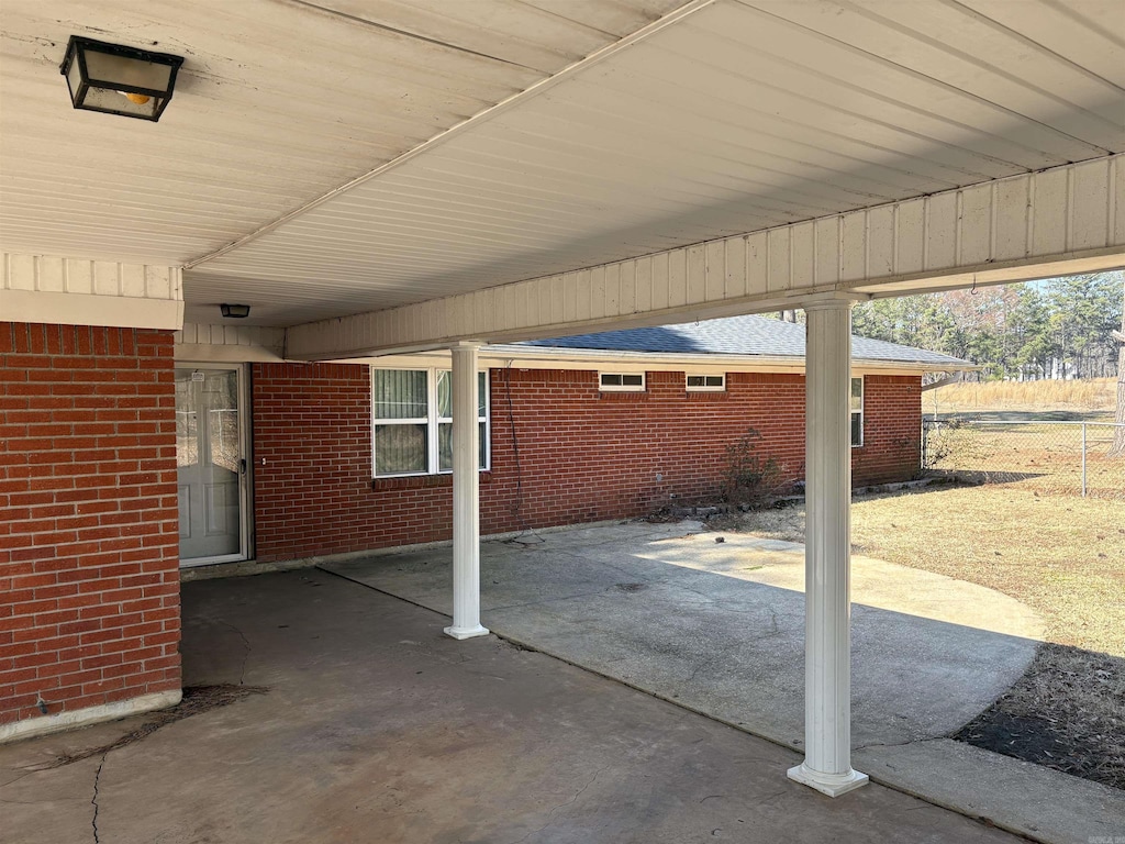 view of patio featuring fence and an attached carport