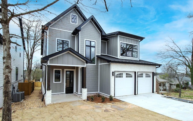 view of front of property with a garage, a standing seam roof, board and batten siding, and concrete driveway