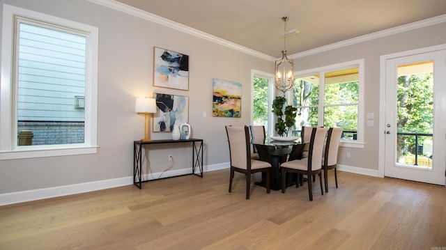 dining space with a chandelier, crown molding, light wood-style flooring, and baseboards