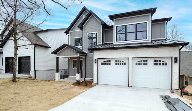 view of front of home featuring driveway, a standing seam roof, a garage, and board and batten siding