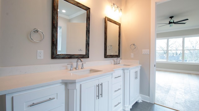 bathroom featuring double vanity, crown molding, and a sink