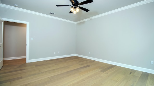 spare room featuring visible vents, baseboards, ceiling fan, ornamental molding, and light wood-style floors