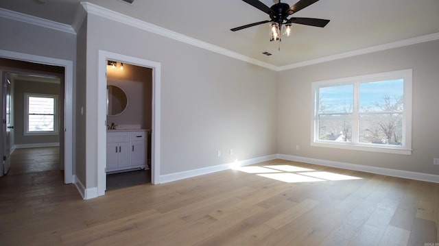 unfurnished bedroom with light wood finished floors, baseboards, visible vents, and ornamental molding