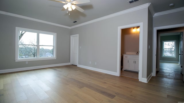 unfurnished bedroom featuring baseboards, ornamental molding, and wood finished floors