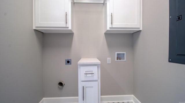 washroom with baseboards, hookup for a washing machine, cabinet space, and hookup for an electric dryer