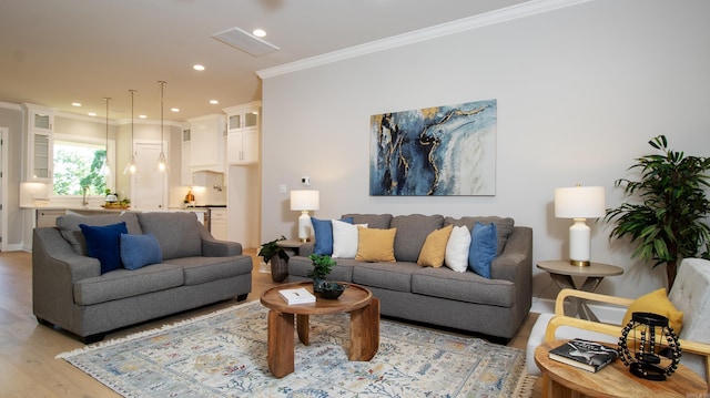 living room with baseboards, light wood finished floors, recessed lighting, and crown molding