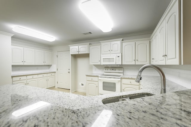 kitchen featuring light stone countertops, white appliances, a sink, visible vents, and decorative backsplash