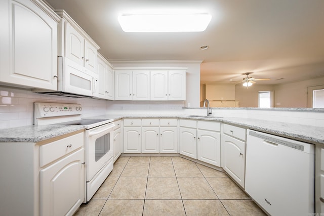 kitchen featuring white appliances, light tile patterned floors, backsplash, and a sink