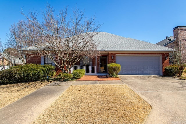 single story home with brick siding, a shingled roof, covered porch, concrete driveway, and a garage