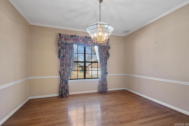 unfurnished room with baseboards, a chandelier, wood finished floors, and ornamental molding