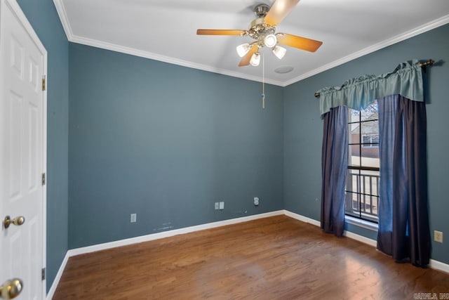 spare room featuring a ceiling fan, crown molding, baseboards, and wood finished floors