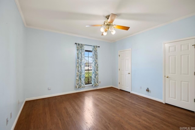 empty room featuring ornamental molding, wood finished floors, a ceiling fan, and baseboards