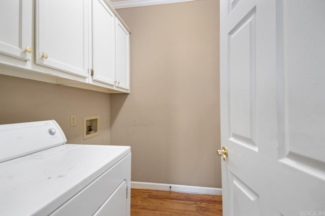 laundry area featuring washer / dryer, baseboards, light wood-style floors, and cabinet space