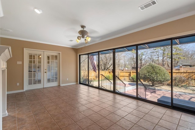 tiled empty room featuring ornamental molding, french doors, visible vents, and baseboards